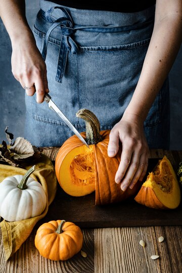 woman cutting thick walled pumpkin
